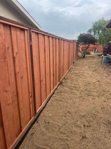 Cedar privacy fence panel with dark stained posts and rails