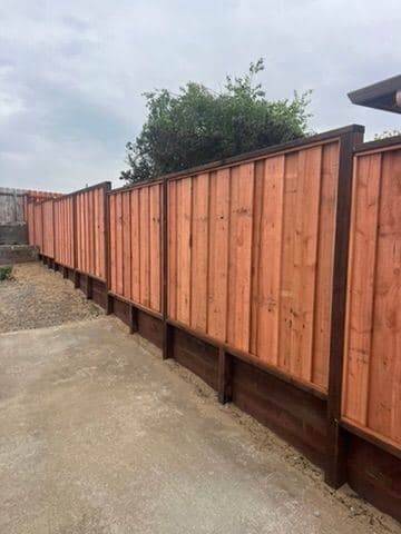Finished cedar privacy fence raised on a kickboard